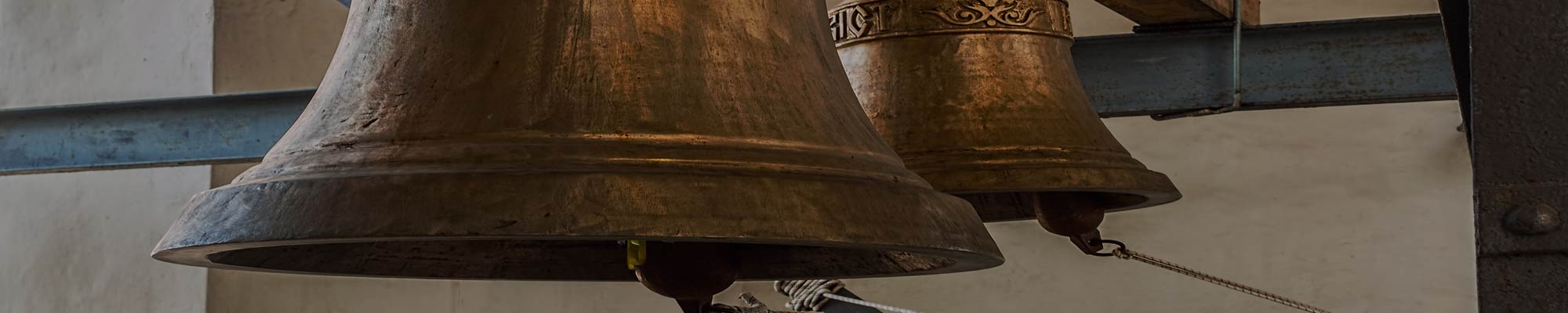 Large church bells hanging in the bell tower of a Catholic church